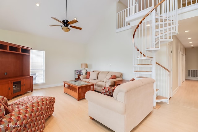 4013 Haiti St, Bay Saint Louis, MS 39520 - living room featuring high vaulted ceiling, stairway, wood finished floors, ceiling fan, and visible vents
