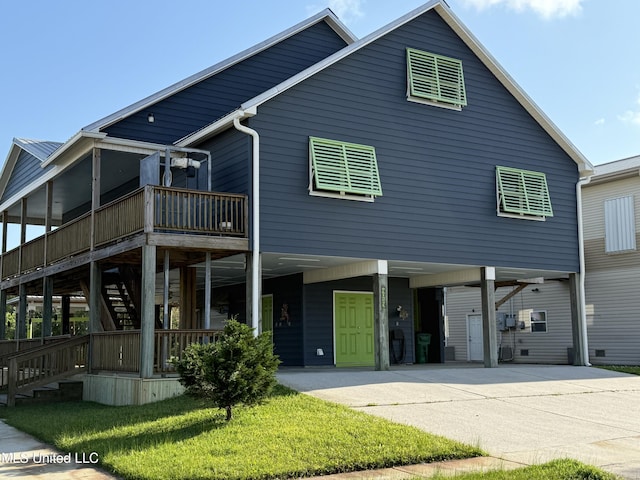 4013 Haiti St, Bay Saint Louis, MS 39520 - raised beach house featuring concrete driveway, stairway, a carport, and a deck
