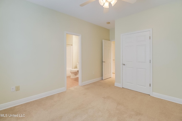 4013 Haiti St, Bay Saint Louis, MS 39520 - unfurnished bedroom with baseboards, ensuite bath, light colored carpet, and ceiling fan