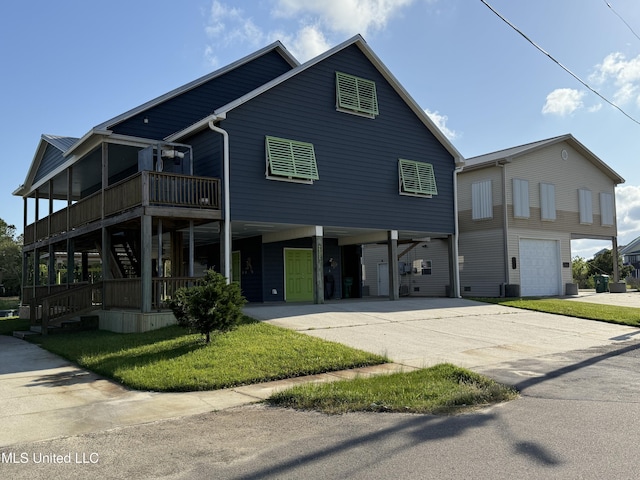 4013 Haiti St, Bay Saint Louis, MS 39520 - view of front facade featuring a carport, a front lawn, stairs, and concrete driveway