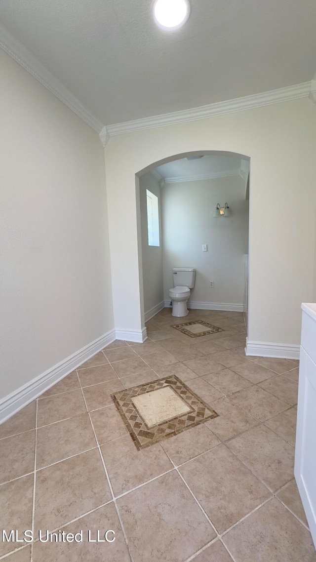 bathroom featuring toilet, tile patterned floors, and crown molding