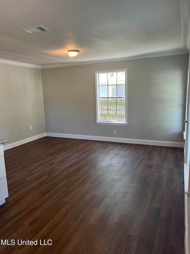 unfurnished room featuring ornamental molding and dark wood-type flooring