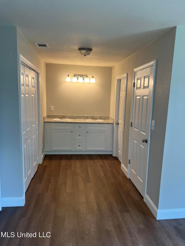 hall featuring dark wood-type flooring and sink