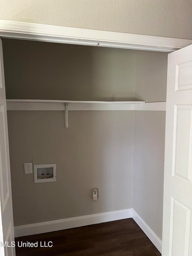 clothes washing area featuring dark hardwood / wood-style floors and washer hookup