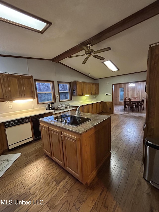 kitchen with hardwood / wood-style flooring, vaulted ceiling with beams, dishwasher, black electric stovetop, and a center island