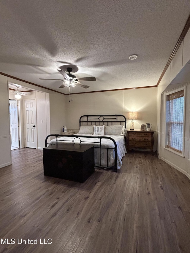 bedroom featuring ceiling fan, crown molding, dark hardwood / wood-style flooring, and a textured ceiling