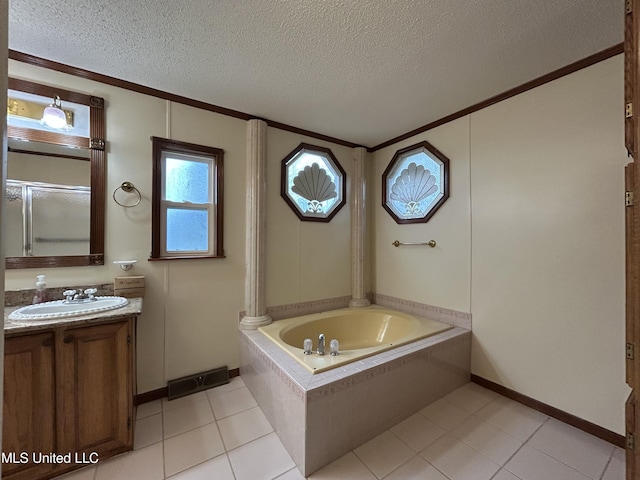 bathroom featuring vanity, a textured ceiling, tile patterned flooring, tiled bath, and ornamental molding