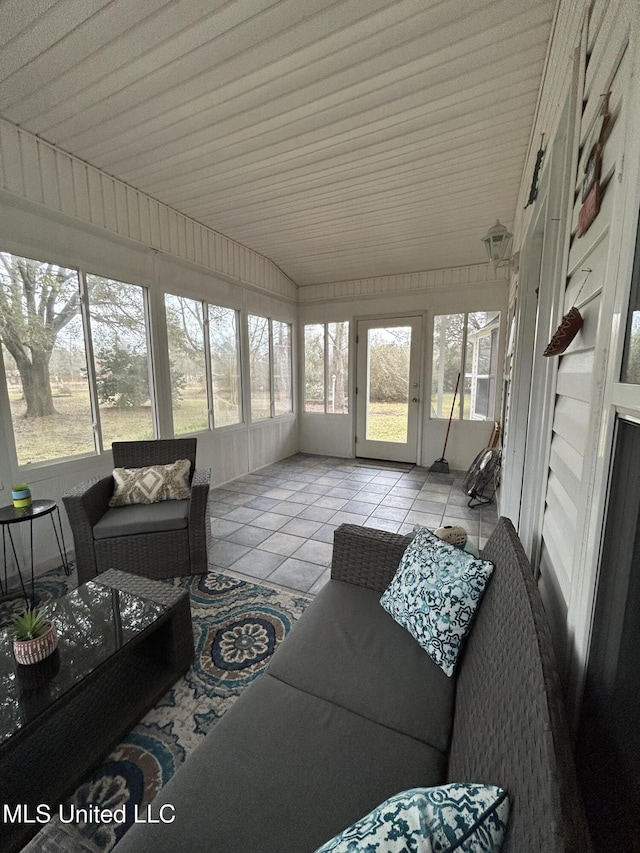 sunroom / solarium featuring vaulted ceiling