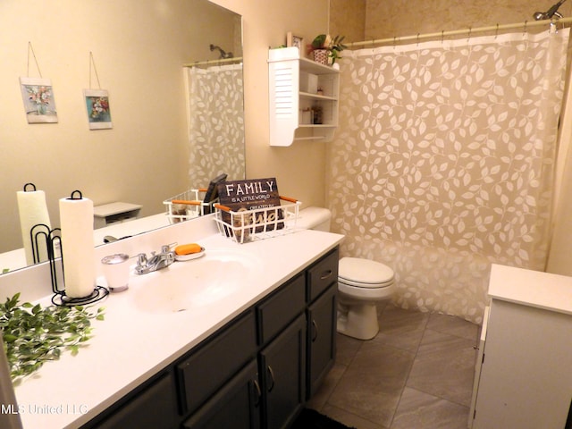 bathroom featuring vanity, toilet, and tile patterned flooring