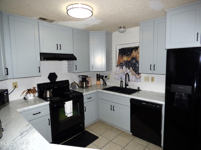 kitchen with backsplash, sink, a textured ceiling, and black appliances