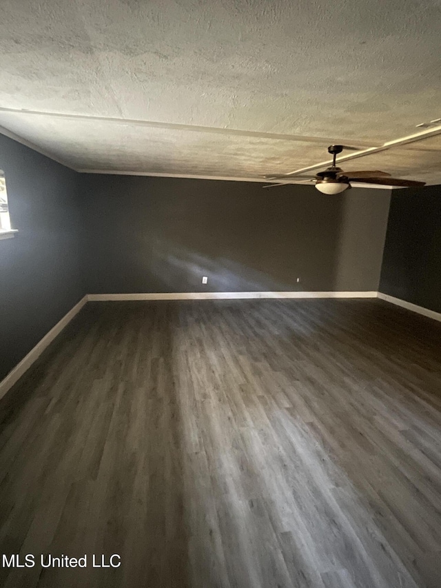 unfurnished room featuring wood-type flooring and a textured ceiling