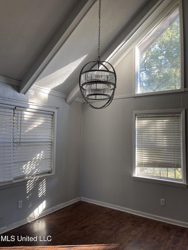 unfurnished dining area with lofted ceiling with beams, ornamental molding, a textured ceiling, a notable chandelier, and dark hardwood / wood-style flooring