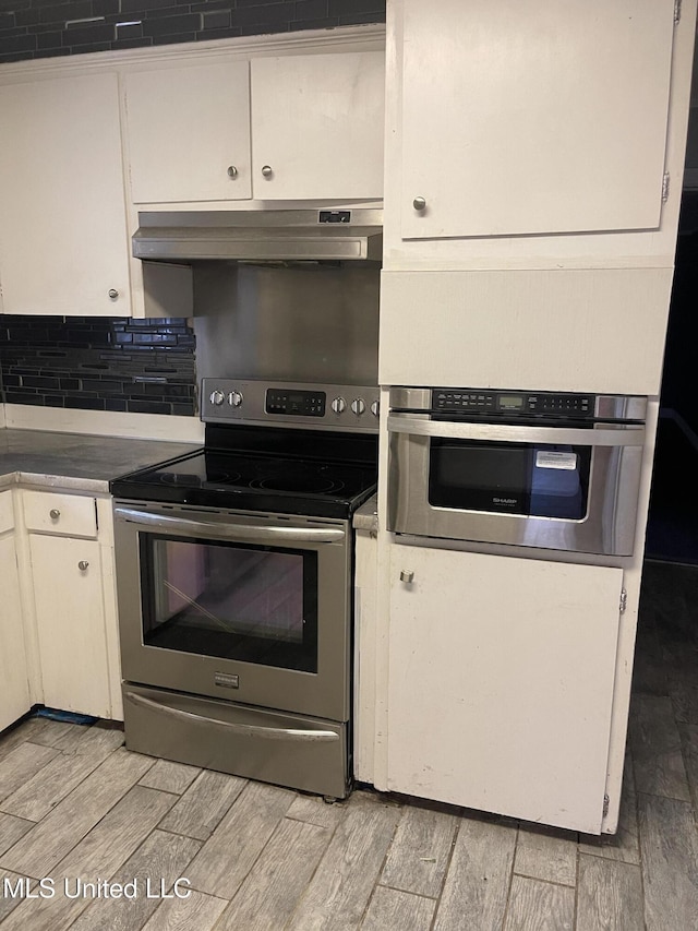 kitchen with white cabinets and appliances with stainless steel finishes