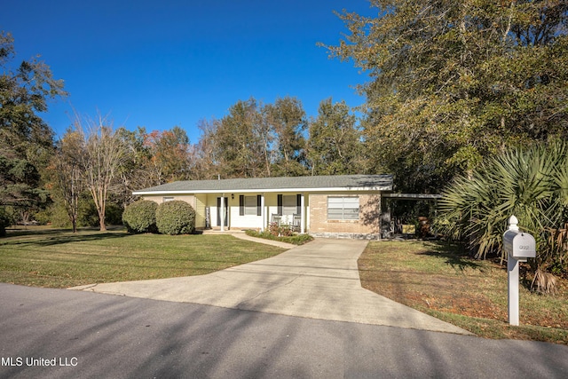 ranch-style home with covered porch and a front lawn