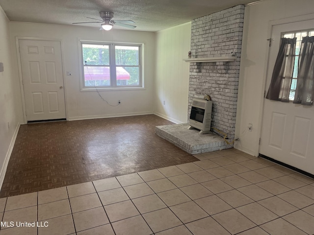 850 Friendship Rd, Ashland, MS 38603 - unfurnished living room with heating unit, ceiling fan, a textured ceiling, baseboards, and a brick fireplace