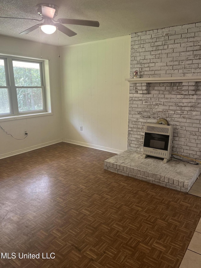 850 Friendship Rd, Ashland, MS 38603 - unfurnished living room featuring heating unit, ceiling fan, baseboards, a textured ceiling, and a fireplace
