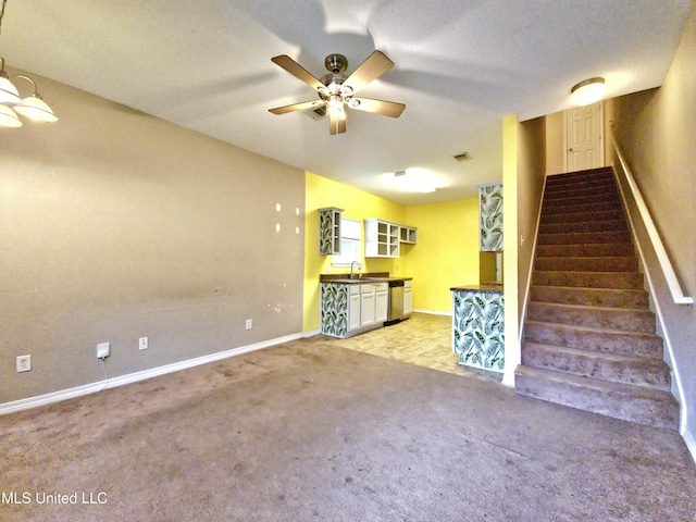 5391 Quail Creek Cir, Diberville, MS 39540 - unfurnished living room with light carpet, stairs, and a ceiling fan