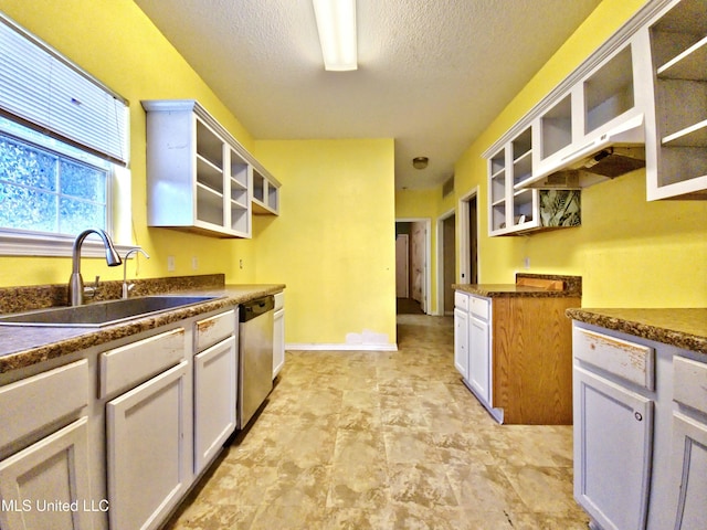 5391 Quail Creek Cir, Diberville, MS 39540 - kitchen featuring dishwasher, open shelves, dark countertops, glass insert cabinets, and a textured ceiling