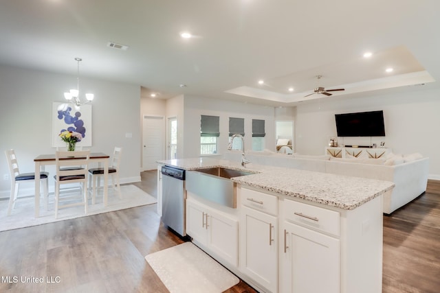 11625 Talla Dr, Ocean Springs, MS 39564 - kitchen with dishwasher, recessed lighting, wood finished floors, light stone counters, and a center island with sink
