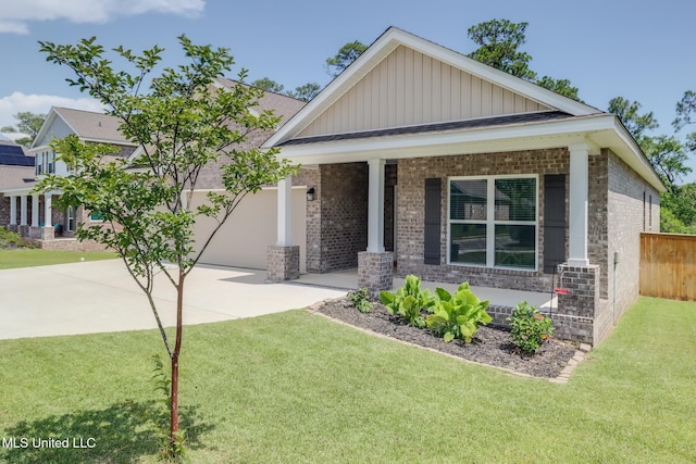 11625 Talla Dr, Ocean Springs, MS 39564 - view of front of house featuring brick siding, driveway, board and batten siding, covered porch, and a garage