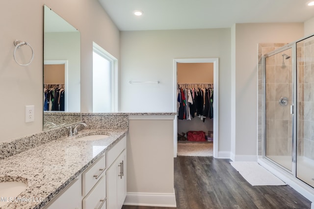 11625 Talla Dr, Ocean Springs, MS 39564 - full bath featuring double vanity, a walk in closet, wood finished floors, a shower stall, and recessed lighting