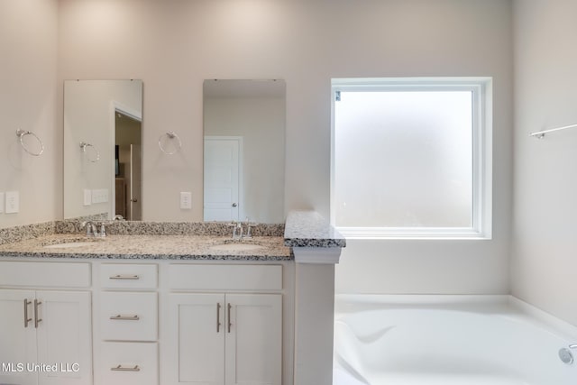 11625 Talla Dr, Ocean Springs, MS 39564 - bathroom featuring healthy amount of natural light, double vanity, and a garden tub