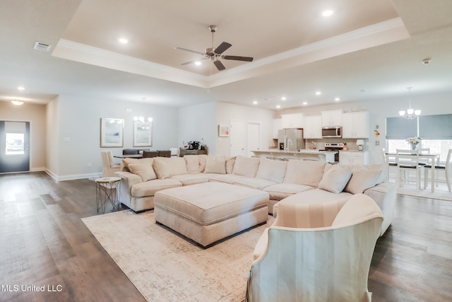 11625 Talla Dr, Ocean Springs, MS 39564 - living room featuring a chandelier, a tray ceiling, a ceiling fan, dark wood-style flooring, and recessed lighting