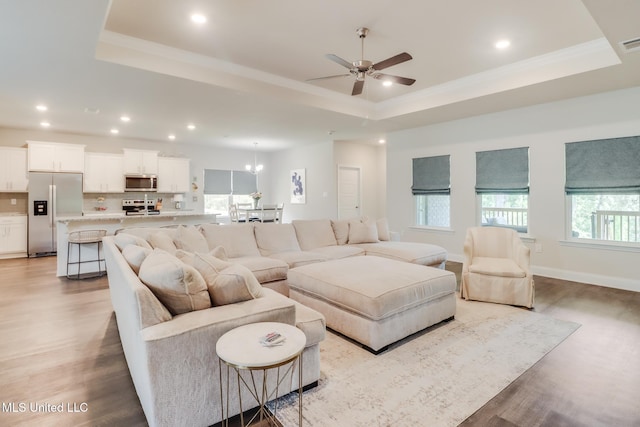 11625 Talla Dr, Ocean Springs, MS 39564 - living area featuring a tray ceiling, light wood-type flooring, ceiling fan, recessed lighting, and crown molding