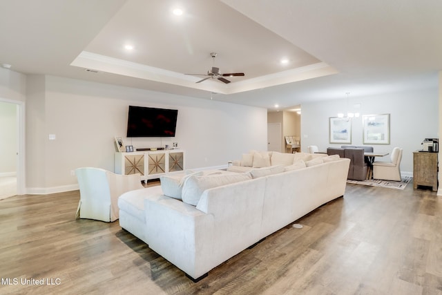 11625 Talla Dr, Ocean Springs, MS 39564 - living room with a raised ceiling, ceiling fan, light wood-type flooring, recessed lighting, and ornamental molding