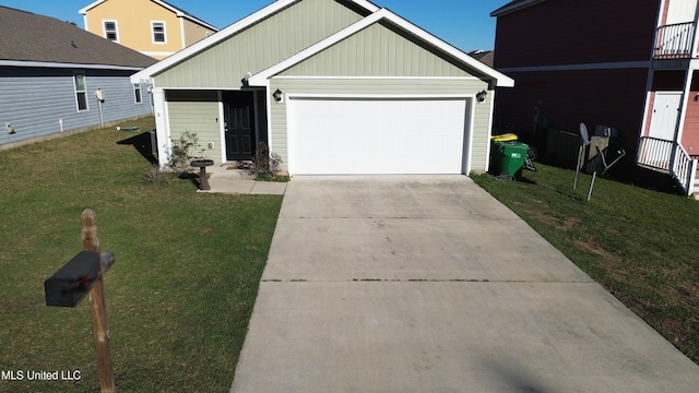 view of front of property featuring a front yard, concrete driveway, and an attached garage