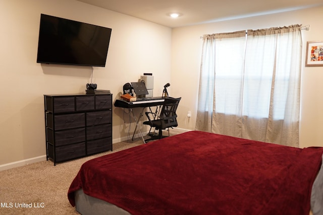 carpeted bedroom with baseboards