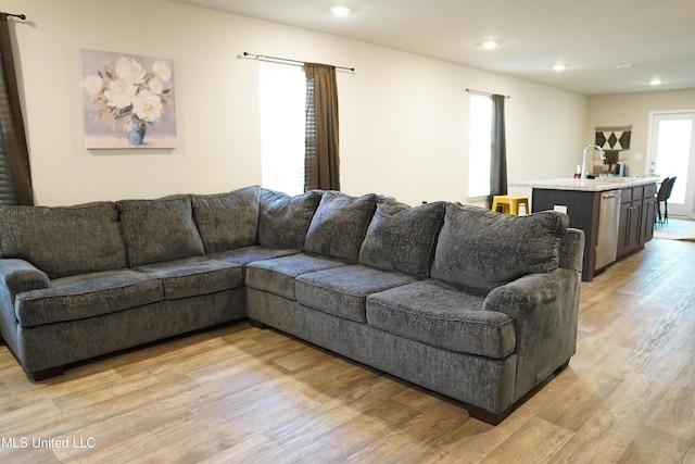 living room with light wood finished floors and recessed lighting