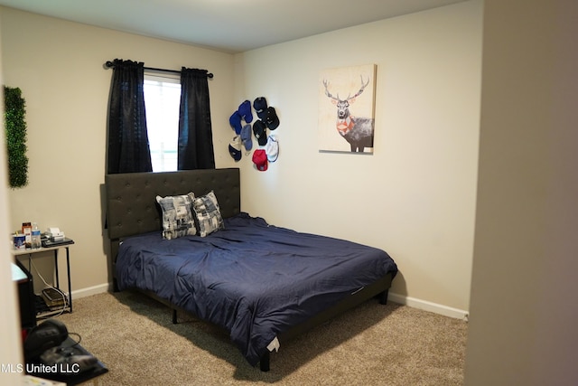 bedroom with carpet and baseboards