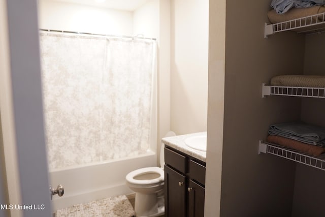 bathroom featuring shower / bath combination with curtain, vanity, and toilet