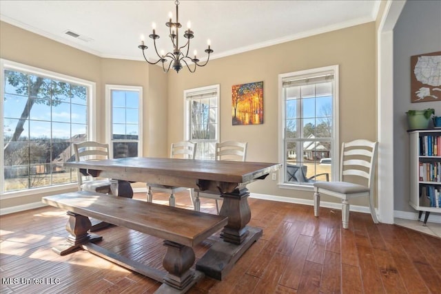 dining area with ornamental molding, dark hardwood / wood-style flooring, and a chandelier