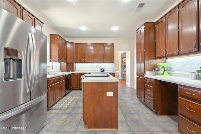 kitchen with stainless steel refrigerator with ice dispenser, sink, black dishwasher, a kitchen island, and backsplash