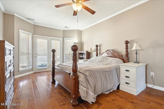 bedroom with dark hardwood / wood-style flooring, ornamental molding, and a textured ceiling