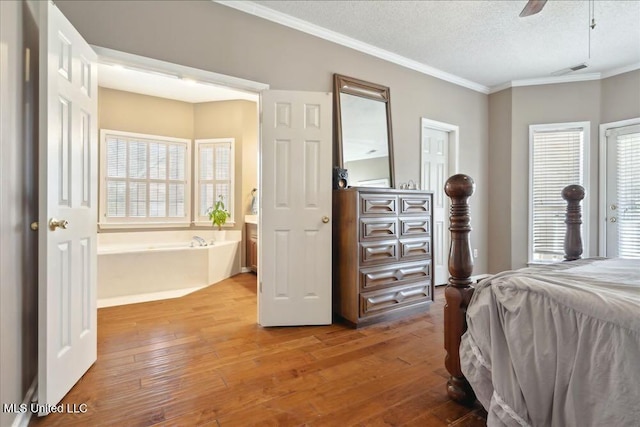 bedroom featuring crown molding, hardwood / wood-style floors, ceiling fan, and a textured ceiling