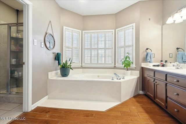 bathroom featuring vanity, independent shower and bath, and wood-type flooring