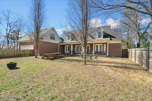 rear view of property featuring a yard