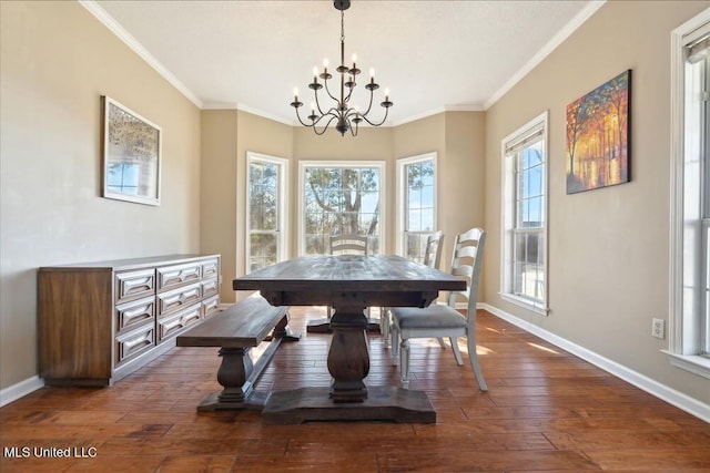 dining area featuring dark wood-type flooring, ornamental molding, and a chandelier