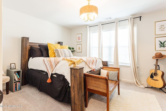 bedroom with light carpet, multiple windows, visible vents, and baseboards