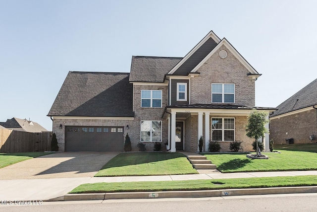 view of front facade with an attached garage, brick siding, fence, concrete driveway, and a front lawn