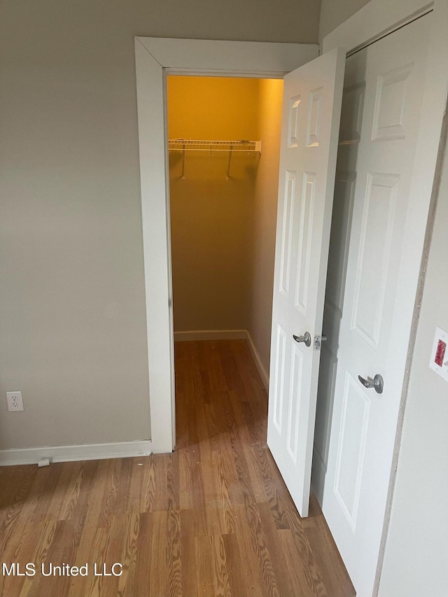 hall with hardwood / wood-style floors