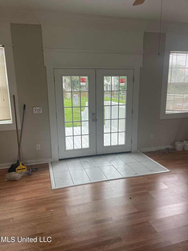 entryway with french doors, light hardwood / wood-style floors, ornamental molding, and ceiling fan