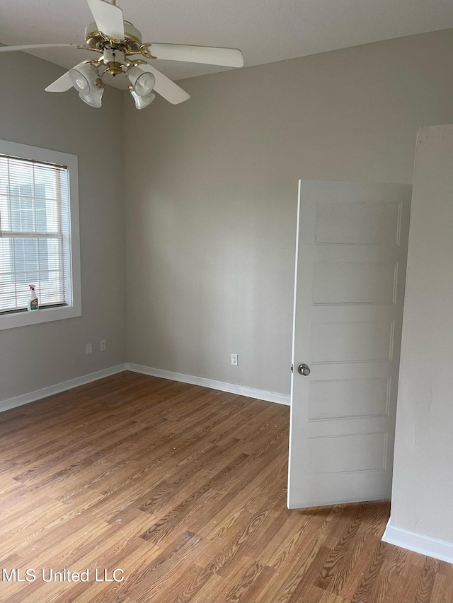 unfurnished room featuring hardwood / wood-style floors and ceiling fan