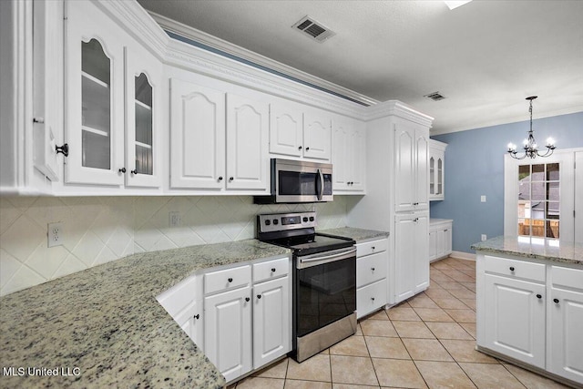 kitchen with crown molding, white cabinets, pendant lighting, and appliances with stainless steel finishes