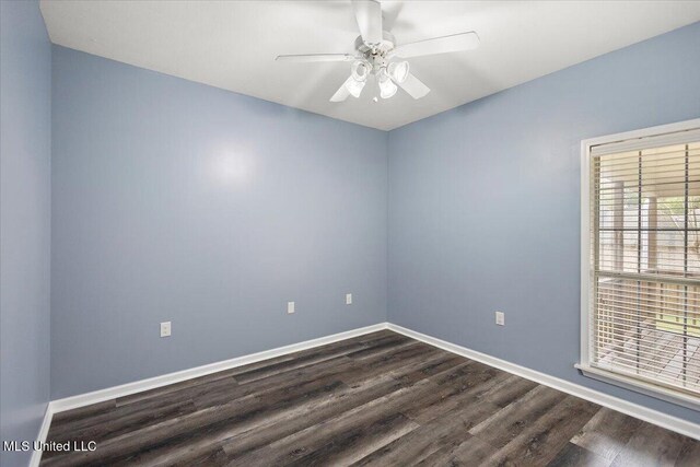 spare room featuring dark hardwood / wood-style flooring and ceiling fan