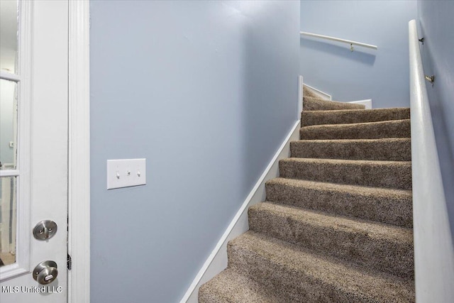 stairs featuring carpet flooring