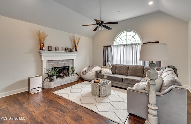 708 Oak Trl, Canton, MS 39046 - living room with vaulted ceiling, a ceiling fan, wood finished floors, a brick fireplace, and baseboards